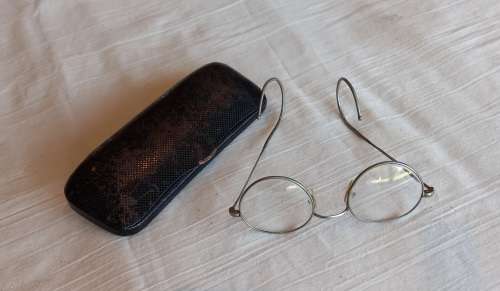 Antique pair of Granny glasses in metal frame, with black metal box.