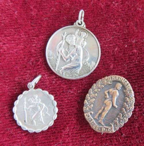 LOT OF TWO STERLING SILVER ST CHRISTOPHER   PENDANTS AND ONE BRASS BROOCH
