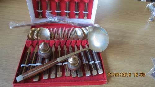 set of 6 knives, folks and spoons in box and 4 skewers,1 large ladle,salt and pepper, as per photo
