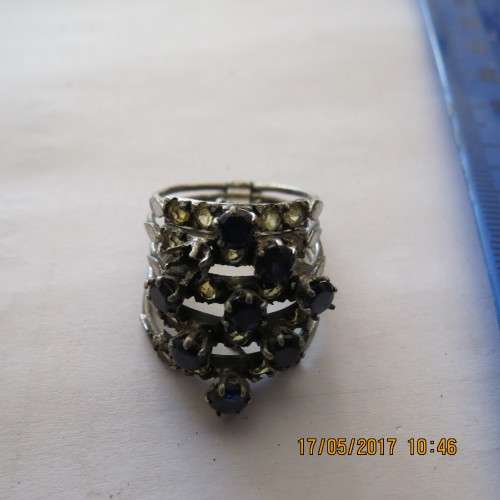 Blue and yellow stone multi ring (5 rings connected at bottom), one blue stone missing, as per photo