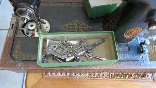 Singer sewing machine in box with accessories, as per photo