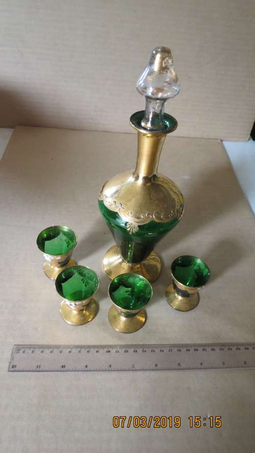 very attractive glass and guilt decanter with four glasses for liqueur, .............as per photo