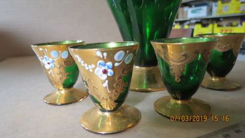 very attractive glass and guilt decanter with four glasses for liqueur, .............as per photo