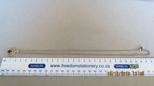 very attractive gold plated pendant and chain, stone looks like a garnet, 53cm long, as per photo