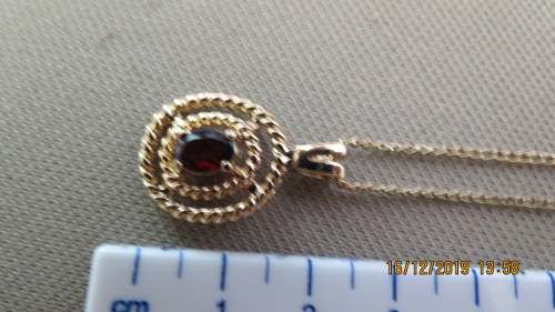 very attractive gold plated pendant and chain, stone looks like a garnet, 53cm long, as per photo