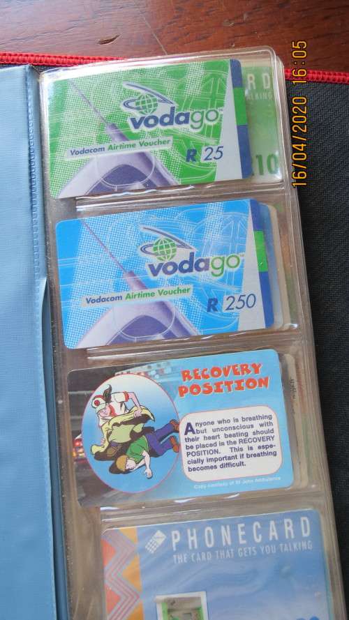 collection of 40 telephone cards in album, as per photo