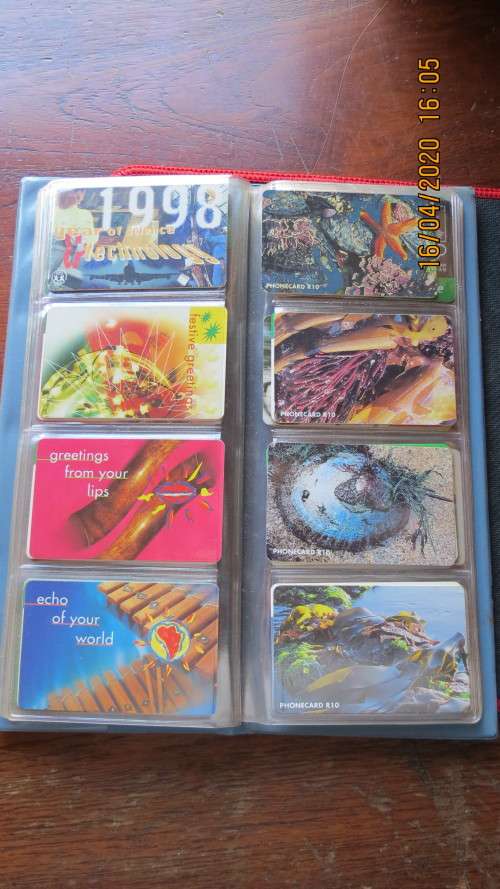 collection of 40 telephone cards in album, as per photo