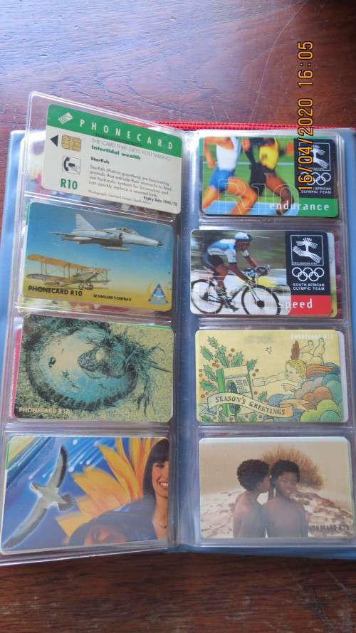 collection of 40 telephone cards in album, as per photo