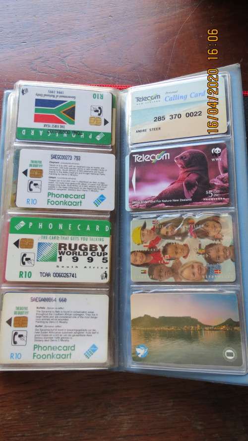 collection of 40 telephone cards in album, as per photo