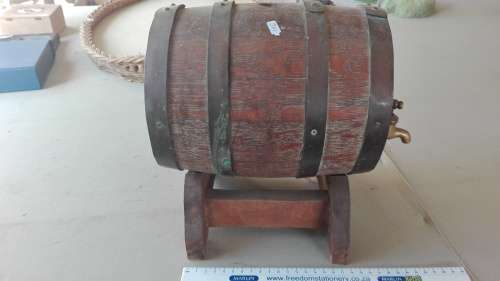 old oak barrel with brass tap on stand,barrel 23cm long, 17.5cm diameter,plug missing,as per photo