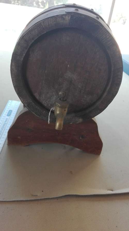 old oak barrel with brass tap on stand,barrel 23cm long, 17.5cm diameter,plug missing,as per photo