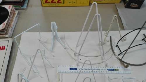 box of plate stands, 29, some are chipped and peeling, and four plate hangers, as per photos