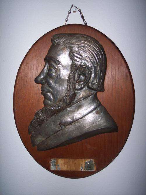 Wood plate Metal bust of President Paul Kruger