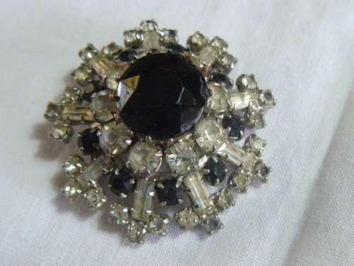 RAISED SLVER TONED BROOCH WITH BLACK STONED AND BLING