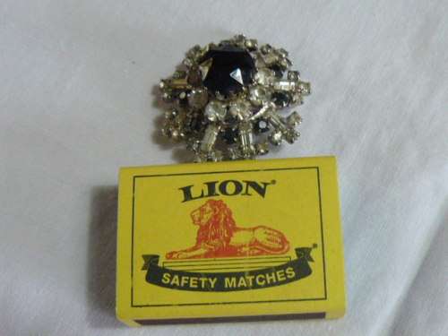 RAISED SLVER TONED BROOCH WITH BLACK STONED AND BLING