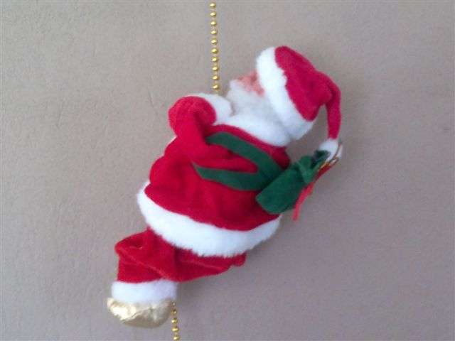 Climbing, singing Santa