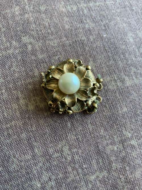 Necklace clasp part of pearl necklace