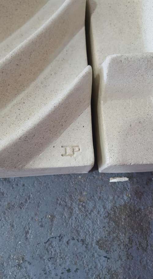 Unique plastered finish/cement type material. Wall hanging--great appeal,funky,modern!!