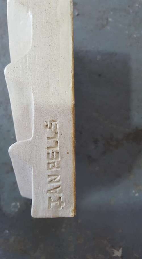 Unique plastered finish/cement type material. Wall hanging--great appeal,funky,modern!!