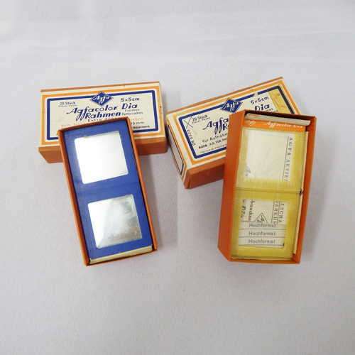 Two boxes with 28 glass slide frames altogether