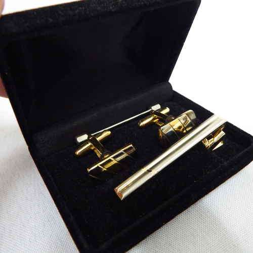 Set of cufflinks and tie clip