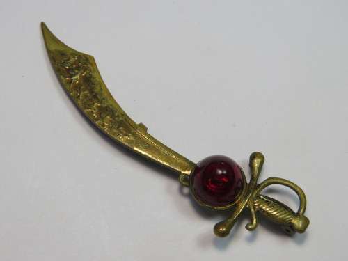 Sword with red stone brooch
