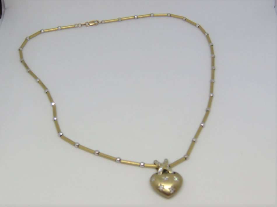 9kt Gold necklace and heart shaped pendant with 21 small diamonds - Weighs 12.9 grams