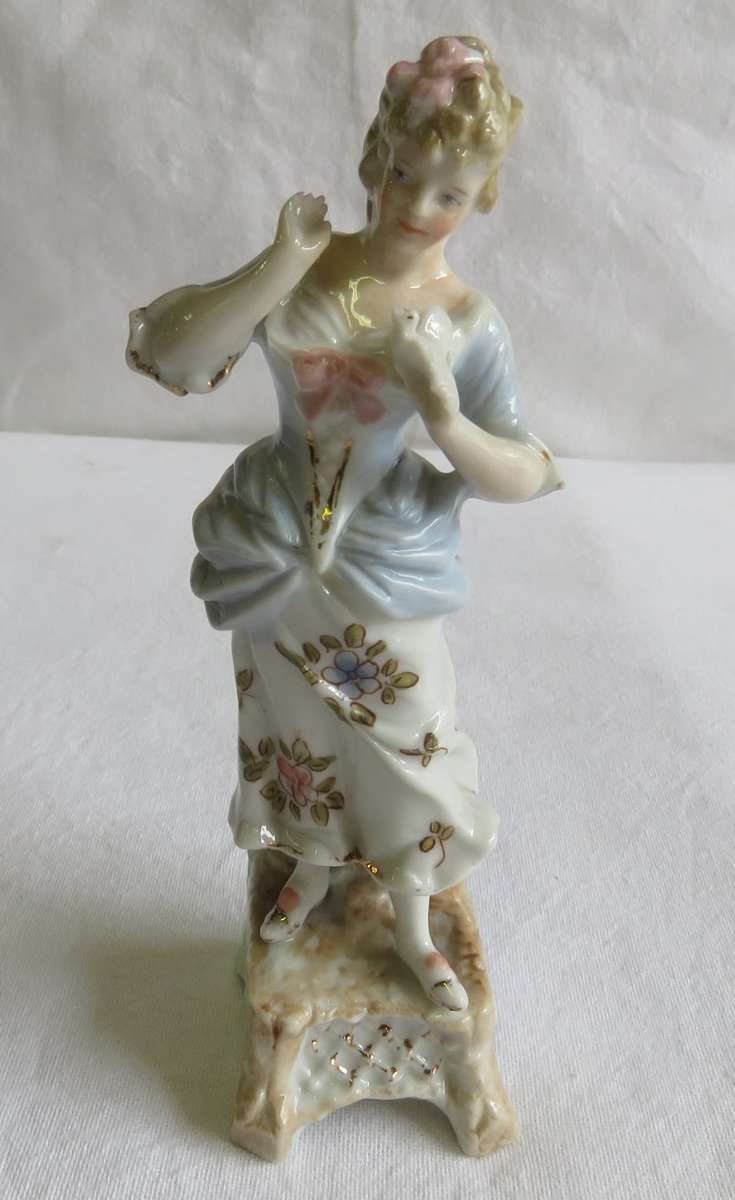 Continental C 1900 woman holding dove figurine - One finger damaged