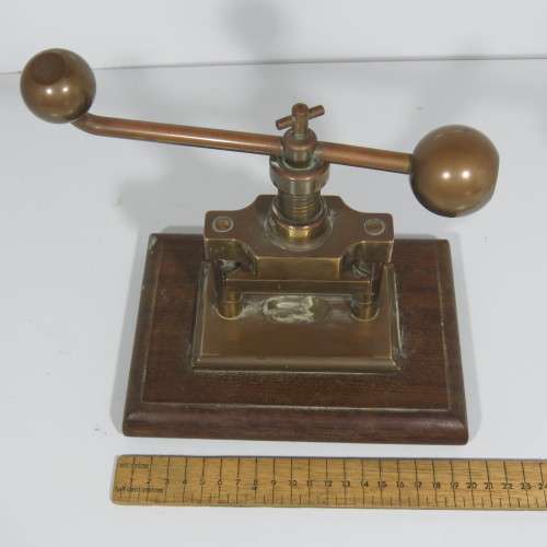 Antique brass nutcracker press on wooden piece