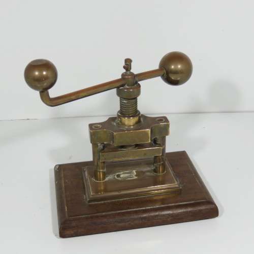 Antique brass nutcracker press on wooden piece