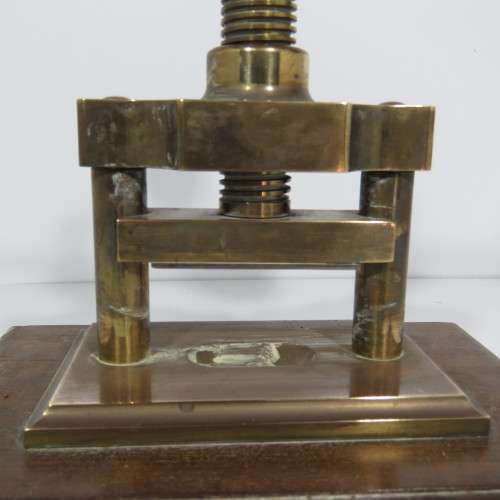 Antique brass nutcracker press on wooden piece