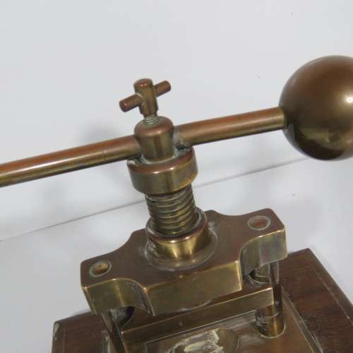 Antique brass nutcracker press on wooden piece