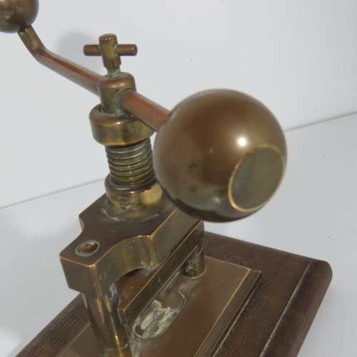 Antique brass nutcracker press on wooden piece