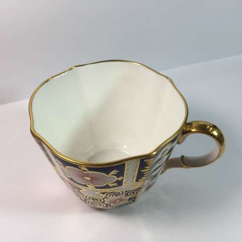 Royal Crown Derby porcelain trio with gold paint