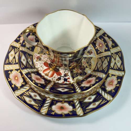 Royal Crown Derby porcelain trio with gold paint