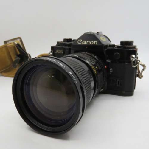 Vintage Cannon A1 35mm camera with 35-105mm zoom lens f1:3.5 - some scratches - advance lever stuck