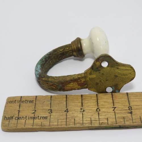 Vintage brass hook with porcelain knob