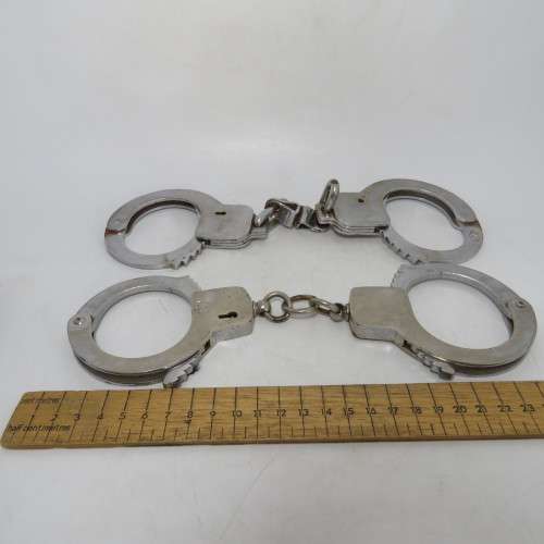 Two pairs of old SA Police handcuffs in pouch