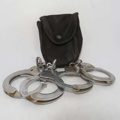 Two pairs of old SA Police handcuffs in pouch