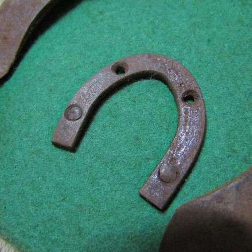 Board with antique horseshoes, some for oxen and ponies originating from South West Africa
