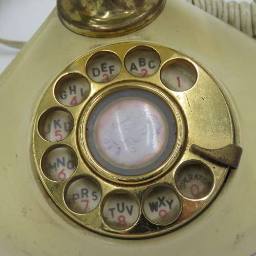 Vintage brass and plastic rotary dial telephone