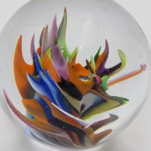 Vintage small handmade glass paperweight with multi-color swirls