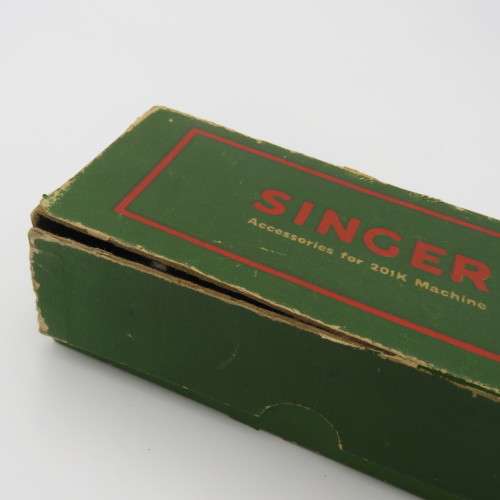 Singer box with various items inside