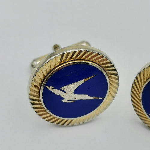 Pair of South African Airways flying springbok cufflinks with blue background