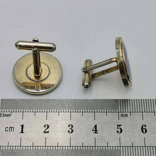 Pair of South African Airways flying springbok cufflinks with blue background