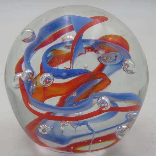 Handmade glass paperweight with bubbles and spiral design