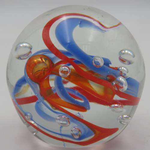 Handmade glass paperweight with bubbles and spiral design