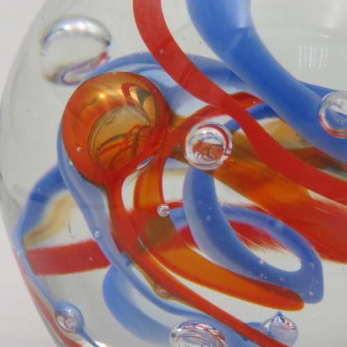 Handmade glass paperweight with bubbles and spiral design