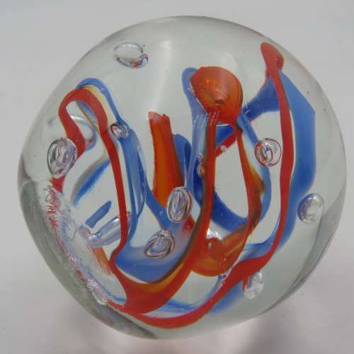 Handmade glass paperweight with bubbles and spiral design
