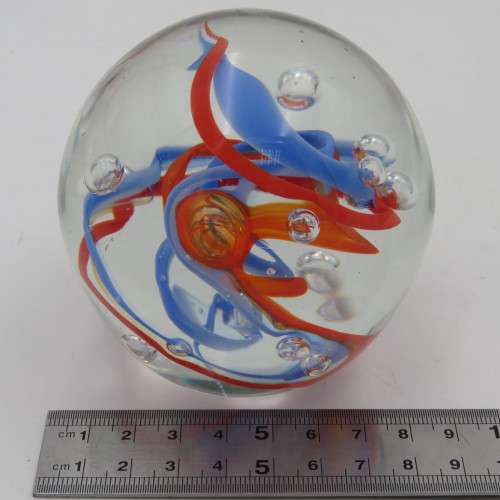 Handmade glass paperweight with bubbles and spiral design